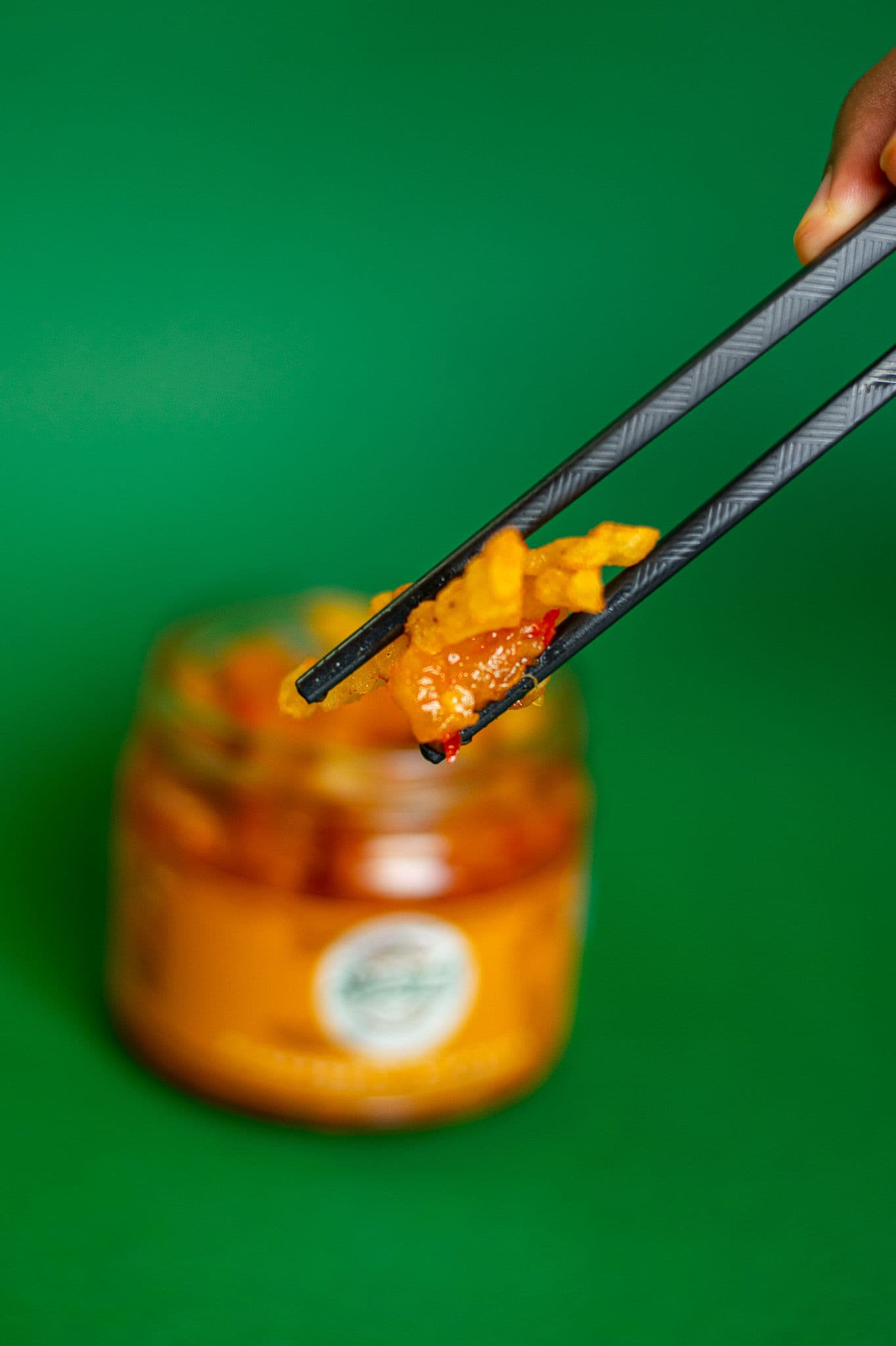 Chutney lifted from a jar with chopsticks
